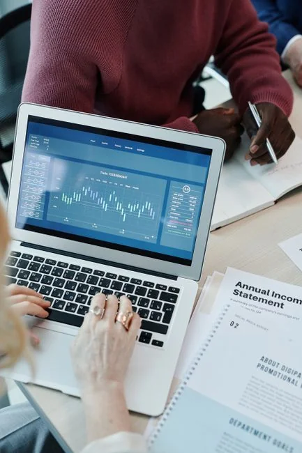 Open planner showing a date with handwritten notes on a wooden desk.